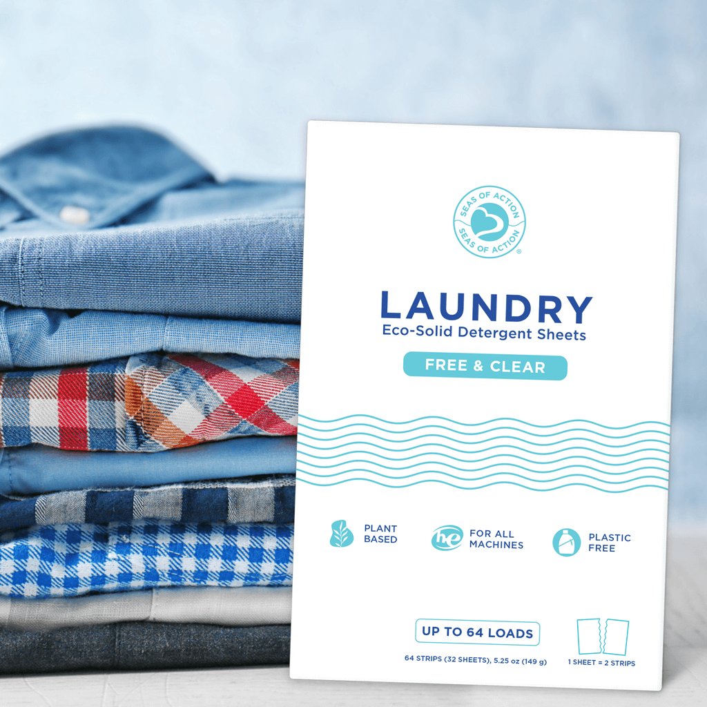Pack of Seas of Action laundry detergent sheets in Free and Clear with folded clothes in the background