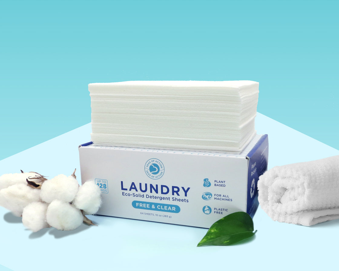 Seas of Action laundry detergent sheets box of 128 loads with a towel, leaf and cotton nearby.